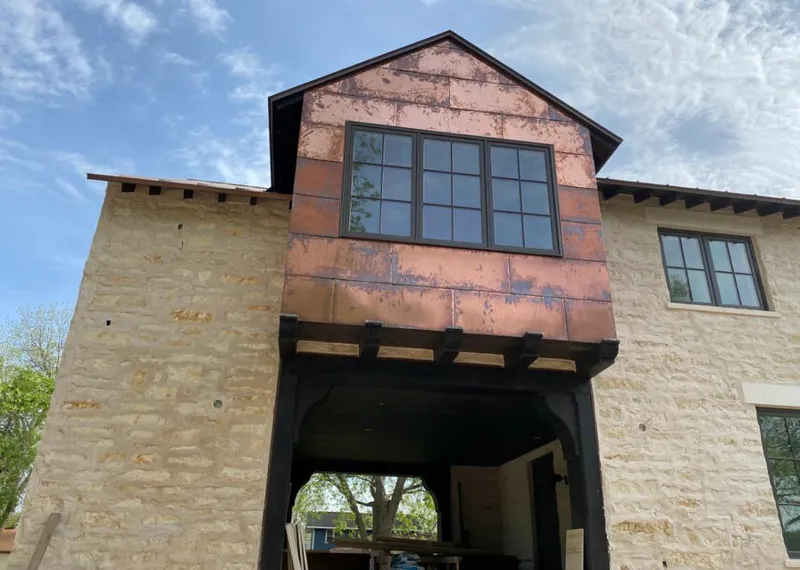 Copper metal panel facade on a stone building for Skylight Installation in Meridian